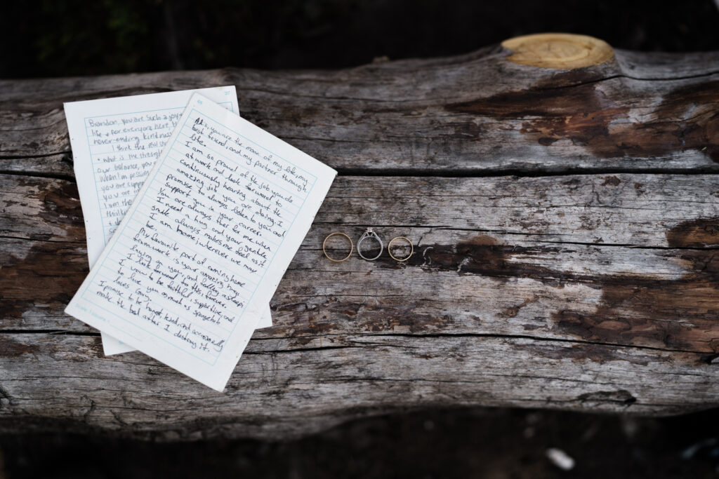 vows and rings placed on a log during elopement