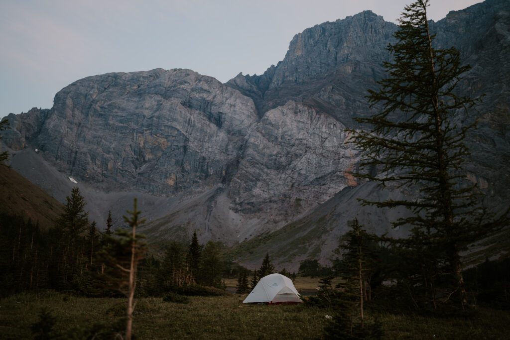 tent set up at the base of a mountain in Kananaskis for backcountry elopement