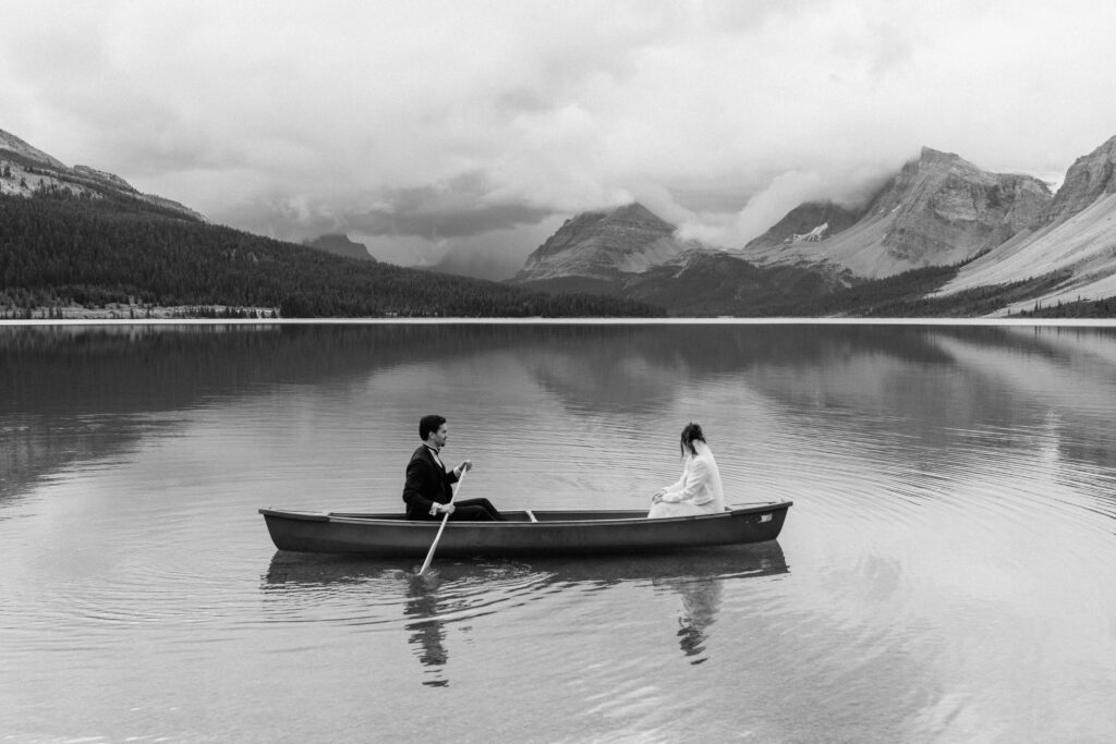 couple canoes on lake during banff elopement