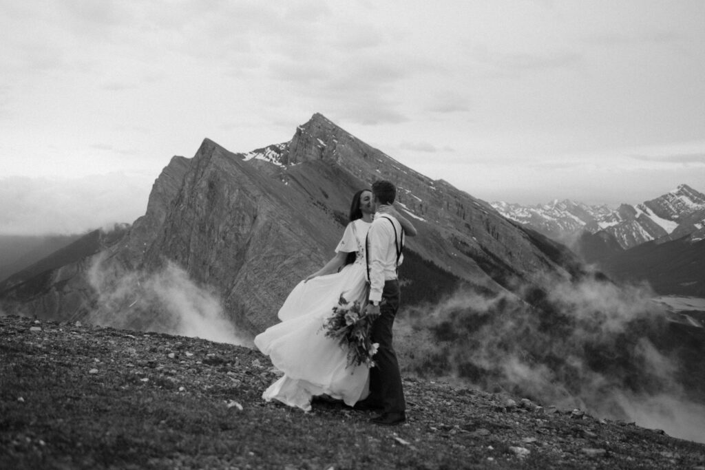 couple kisses during hiking elopement in Banff