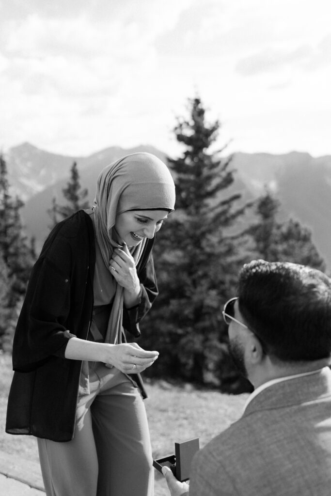 girl in headscarf smiles at ring during banff proposal