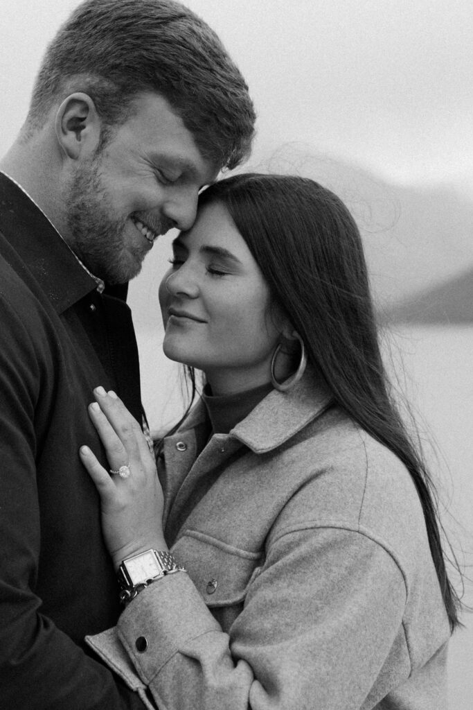 couple snuggles up after banff proposal