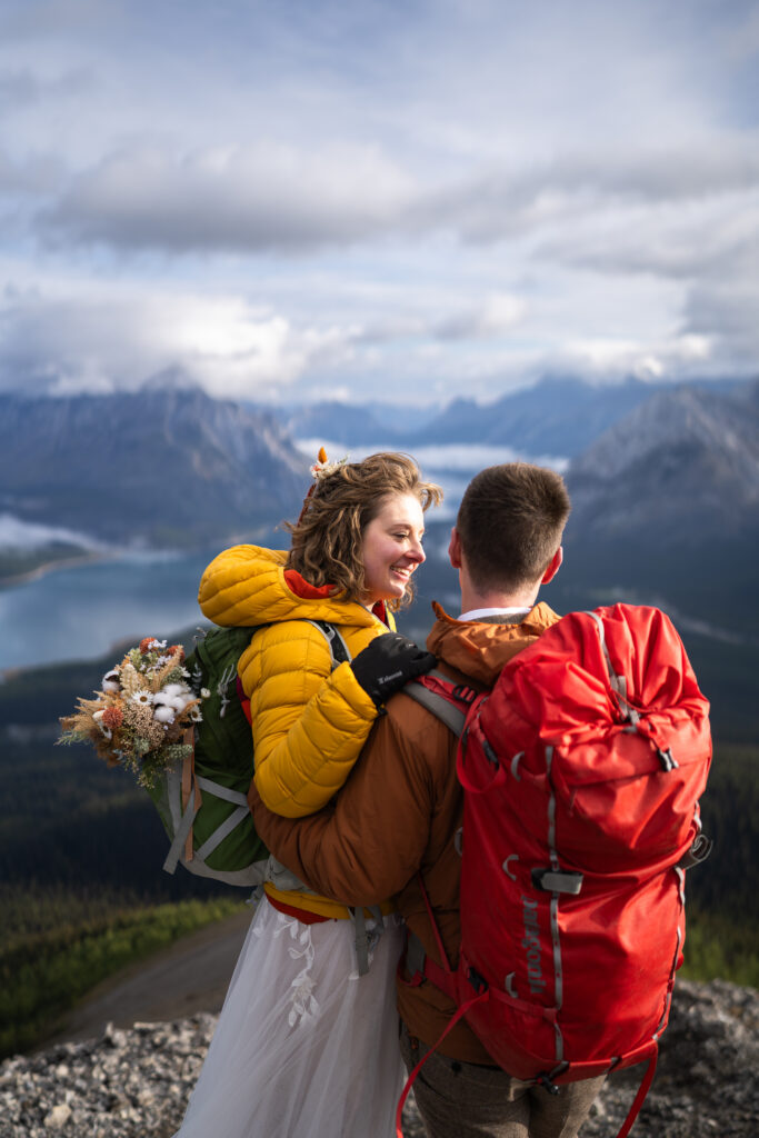 bride and groom smile at each other during sunrise Kananaskis elopement