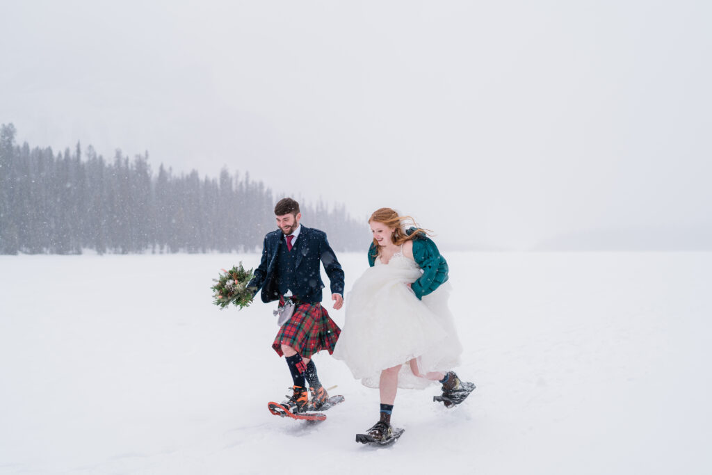 groom in traditional scottish attire runs beside bride 