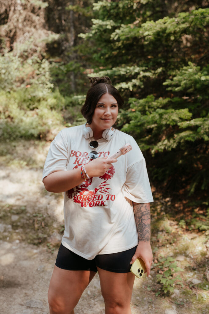 bride holds up a mini fan during kananaskis hiking elopement