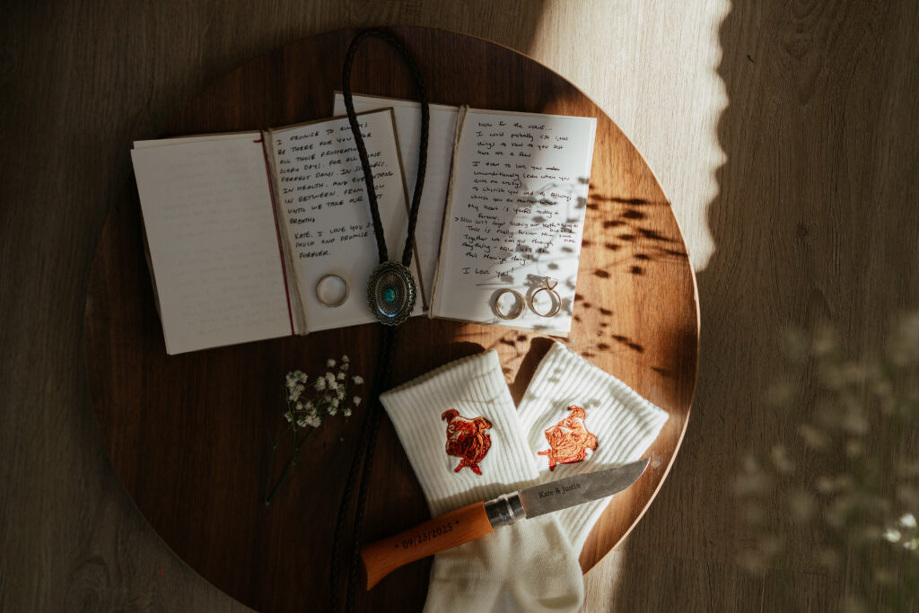 elopement accessory details on a round table with the sun streaming through