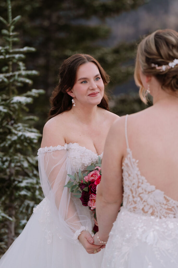 bride looks at other bride during ceremony