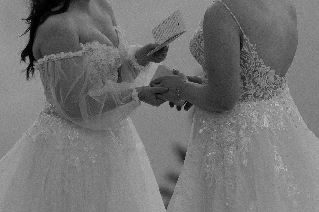 brides hold hands during ceremony