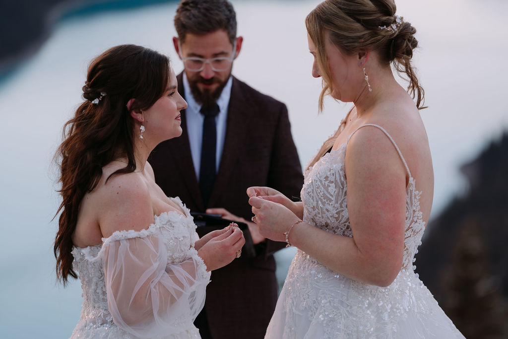 brides exchange rings during peyto lake elopement