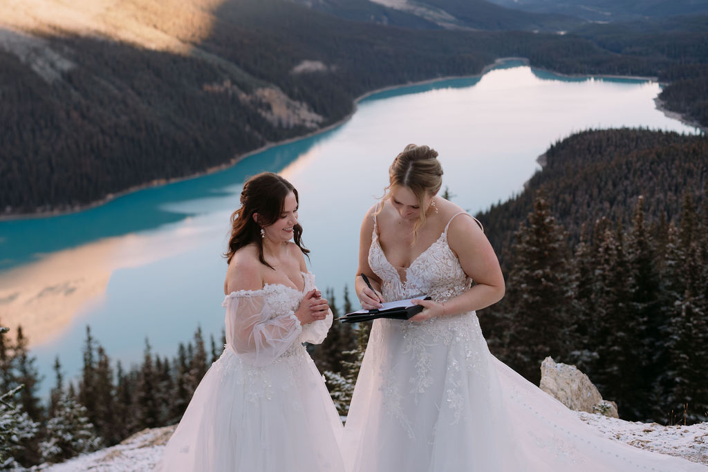 brides sign paperwork during banff elopement