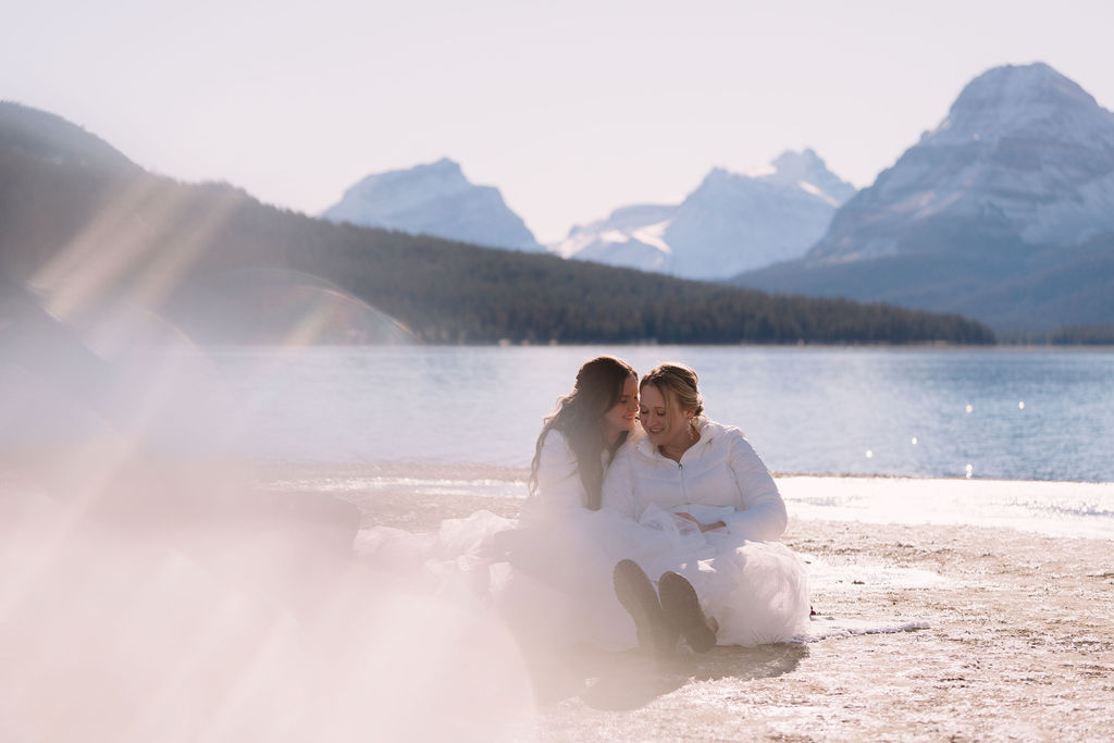 brides snuggle up on the shores of bow lake