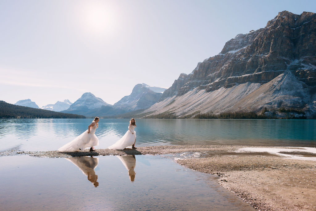 brides run down shores of Bow Lake during October elopement