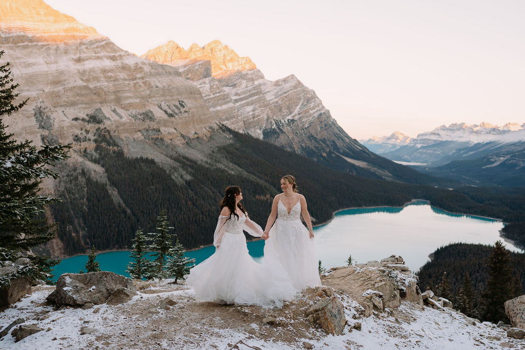 brides hold hands during peyto lake elopement